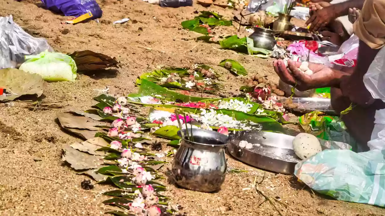 Photo of a devotee's hand holding pinds for performing pind daan- Pitrupaksha and Nitya Karma